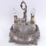 A Victorian silver plated 6-bottle condiment stand with cast handle