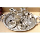 An oval silver plated 2-handled serving tray, a pair of plated chamber sticks, a pair of
