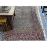 An Antique red ground Persian rug, 200cm x 140cm