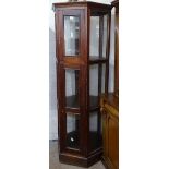 A modern hardwood and glazed octagonal display cabinet, H182cm