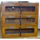 A Vintage oak-framed table-top shop display cabinet, with 3 glass-fronted drawers, for Peter Pan