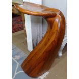 A sculptured laminated wood dolphin tail barstool