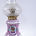 A 19th century pink and white ceramic oil lamp converted to candle holder, with frosted frilled