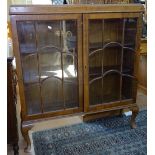 A 1920s walnut bookcase with 2 lattice glazed doors, W97cm