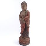 An Oriental carved and painted wood standing Buddha figure, height 56cm