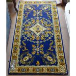 A blue and gold ground English wool rug, 178cm x 93cm