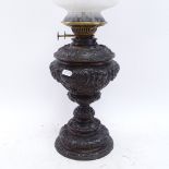 A cast-iron Duplex oil lamp, with mottled frilled glass shade and chimney, overall height 60cm