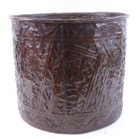 A Middle Eastern copper barrel, relief embossed Arabic script with deer decoration, height 33cm