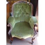 A Victorian walnut-framed button-back upholstered armchair, on cabriole legs