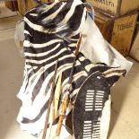 A zebra skin, African Tribal hide shield, bow, spear etc