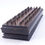 An Antique ebonised flame mahogany Cribbage board, length 28cm