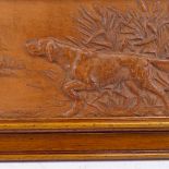 A framed terracotta relief plaque, depicting Gun dog in reeds, frame length 44cm