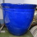 A blue glazed terracotta garden pot