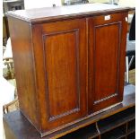 A Victorian mahogany hanging cabinet, the 2 panelled doors opening to reveal 24 fitted pigeon holes,