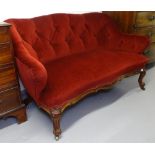 A Victorian button-back upholstered 2-seater settee, with carved mahogany show-wood, on scrolled