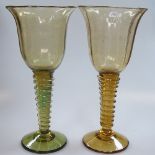 A pair of hand thrown glass goblets with twist stems, 25.5 cm