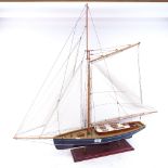 A Vintage painted model boat on stand, hull length 60cm