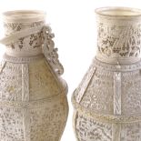 A pair of 19th century Chinese Cantonese ivory vases, carved and pierced sections with village