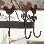 A wrought-iron hanging pot rack, length excluding hooks 60cm
