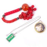 A Chinese sterling silver green stone pendant necklace, Chinese red bead and cinnabar bracelet