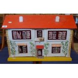 A Vintage child's doll's house with some furniture