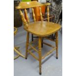 A beech bar stool with spindle back