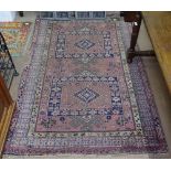 A red ground Persian design rug, 185cm x 120cm
