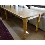 A rectangular pine plank-top kitchen table, on baluster turned legs, L198cm