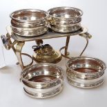 A small Mappin & Webb silver plated warming stand, and 4 small silver plate on copper wine coasters