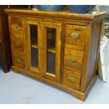 An sheesham wood side cabinet, with glazed panel cupboards and fitted drawers, W103cm