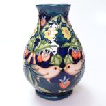 A Moorcroft tube-lined vase with designs of finches and strawberries, height 13cm