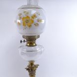 A 19th century brass Corinthian column oil lamp, milk glass floral shade with clear font and