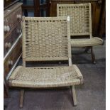 A pair of Yugoslavian folding garden chairs with woven rush seats