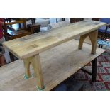 A weathered oak bench on raised stile supports, L152cm