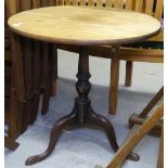 A oak tripod table with circular top.