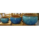 A graduated set of 3 turquoise glazed terracotta circular plant pots