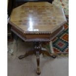 A hardwood octagonal trumpet work table, with games-top and fitted interior, on a quadruple carved