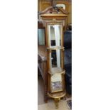 A Theodore Alexander stained and giltwood narrow hanging wall mirror, with integral shelf, and
