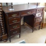 An Edwardian mahogany knee-hole writing desk, with fitted short drawers, W107cm