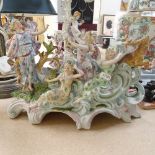 A Continental porcelain table centre, supported by 3 figures and a stag, length 33cm