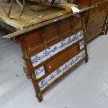 An Edwardian panelled oak hanging hat and coat rack, with inset Delft tiles, W119cm