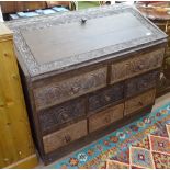 A North African hardwood bureau, with allover chip carved decoration, and fitted with 8 drawers,