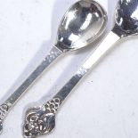 EVALD NIELSEN - a graduated pair of Art Nouveau silver spoons, with floral terminals, and a
