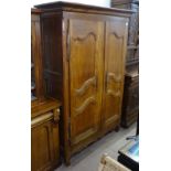 An Antique Continental cherrywood housekeeper's cupboard, with 2 panelled doors and fitted