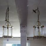 A pair of small brass-framed circular hall lanterns, length not including chain 34cm