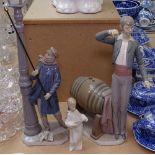 A Lladro lamplighter figure, 47cm, a Lladro figure by a barrel, and a small angel