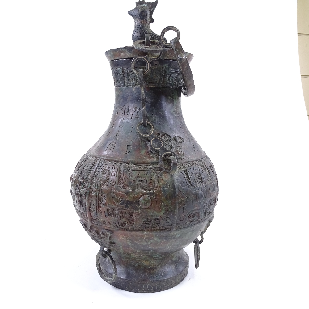 A large Chinese verdigris bronze flagon and cover, with relief moulded decoration and text, bird - Image 4 of 6