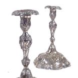 A pair of 19th century German Augsburg table candlesticks, relief embossed floral and foliate