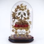 A 19th century French wedding dome, gilt-metal and mirror inset ornament under original glass