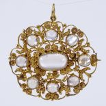 A 19th century unmarked high carat gold cabochon moonstone pendant/brooch, floral cannetille